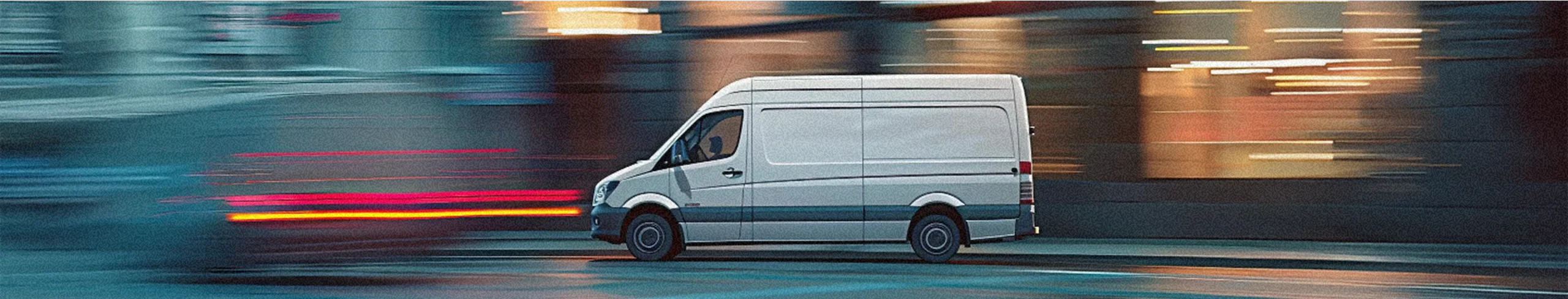 A van driving with a blurred background.