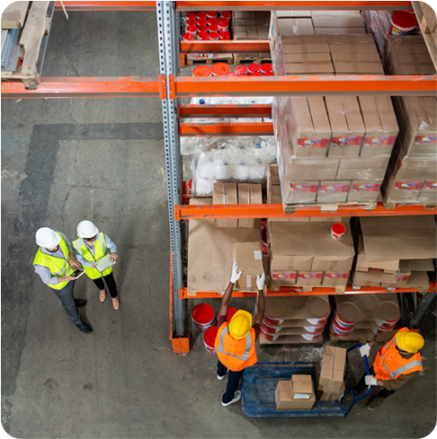 Four men loading and unloading goods from a top-angle view.